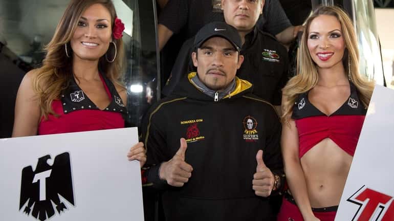 Juan Manuel Marquez, center, poses for photos upon arriving at...
