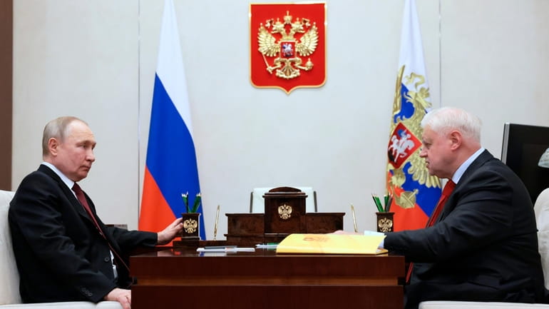 Russian President Vladimir Putin, left, listens to Sergey Mironov, 70,...