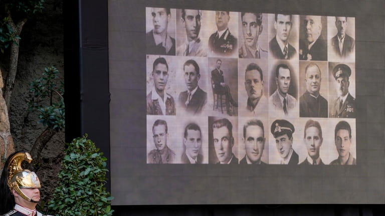 A screen shows photos of the victims of the massacre...