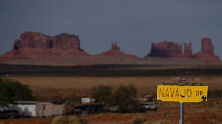A sign marks Navajo Drive, as Sentinel Mesa, homes and...