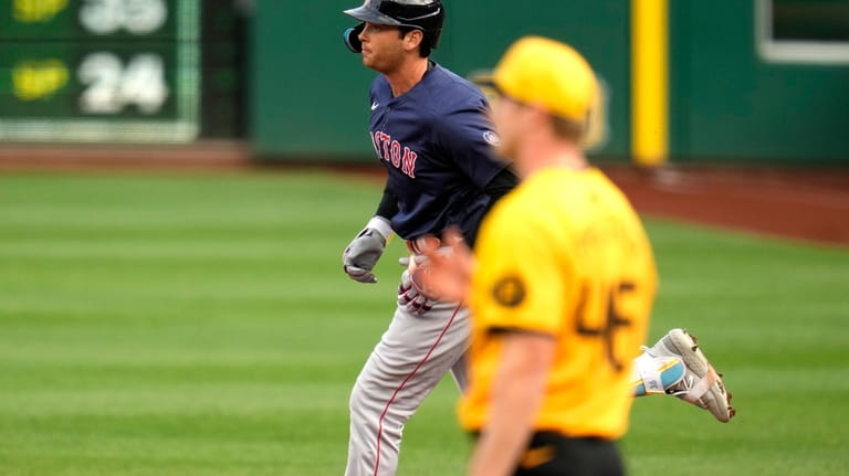 Boston Red Sox's Triston Casas, left, rounds first base after...