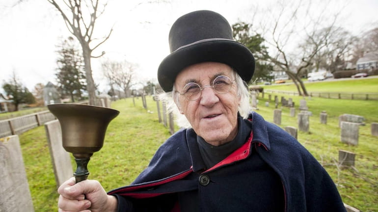 East Hampton Town crier Hugh King stands in the South...