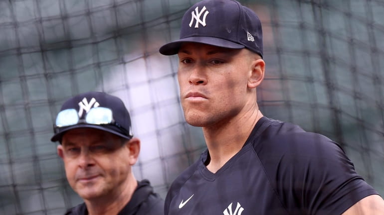 Manager Aaron Boone #17 and Aaron Judge #99 of the...