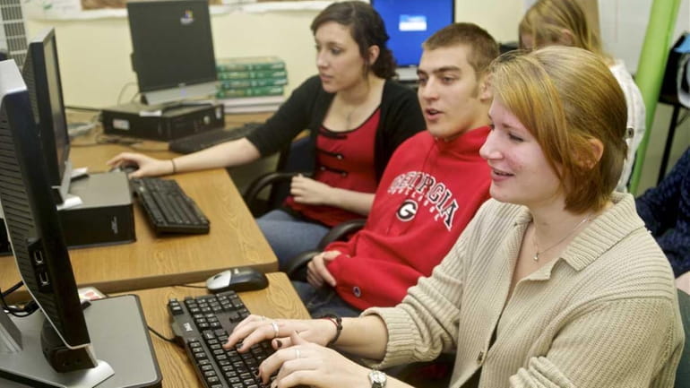 Erin Zseller, 17, front, works with classmates Jacob Greenberg, 17...