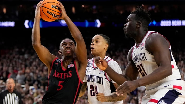 San Diego State guard Lamont Butler (5) drives as UConn...