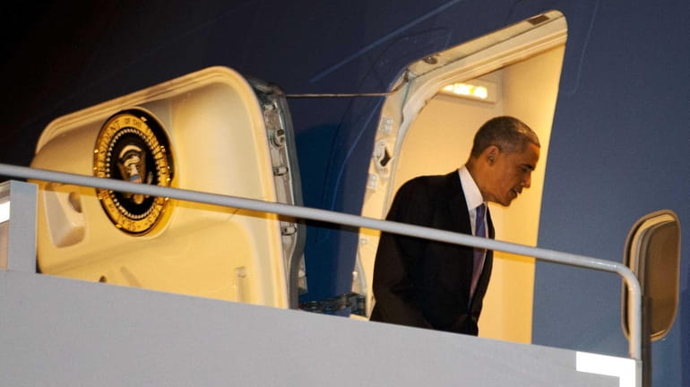 President Barack Obama boards Air Force One in Nashville, Tennessee,...