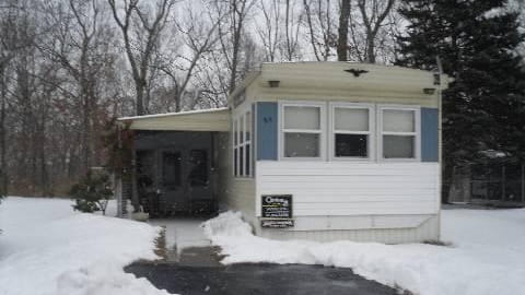 This singlewide two-bedroom, one-bath mobile home in Calverton was built...
