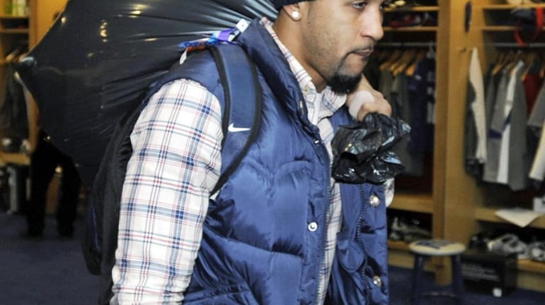The Giants' Terrell Thomas carries his belongings as the Giants...