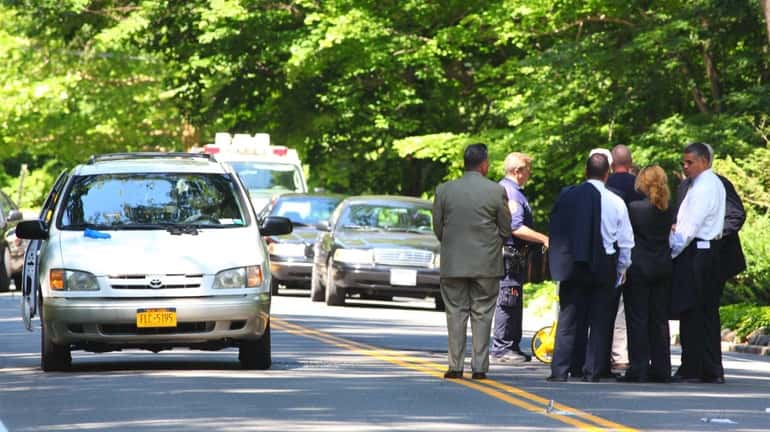 Investigators on Oyster Bay Road in Matinecock, where Nassau police...