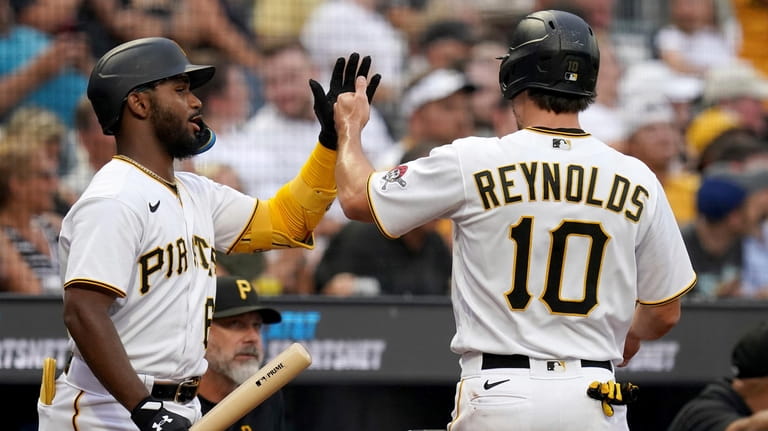 Pittsburgh Pirates' Bryan Reynolds (10) celebrates with teammate Liover Peguero,...