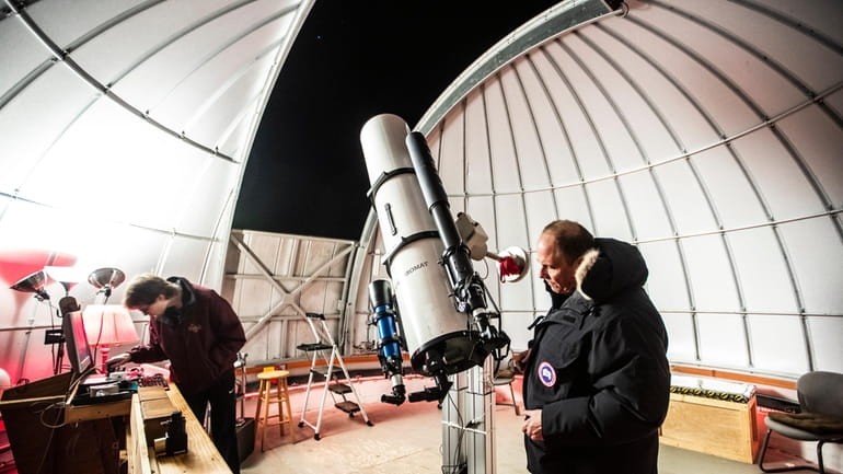 Chuck Cardona sets up a telescope at the Custer Institute...