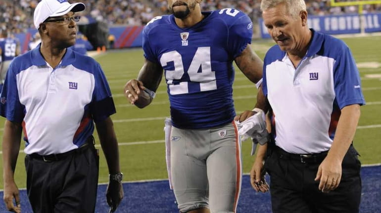 New York Giants cornerback Terrell Thomas leaves the field during...