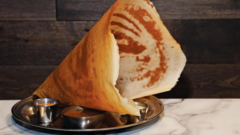 Paper masala dosa filled with potato and served with vegetable...