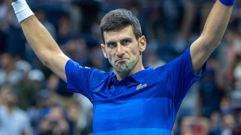 Novak Djokovic reacts with a yell in the fifth set...