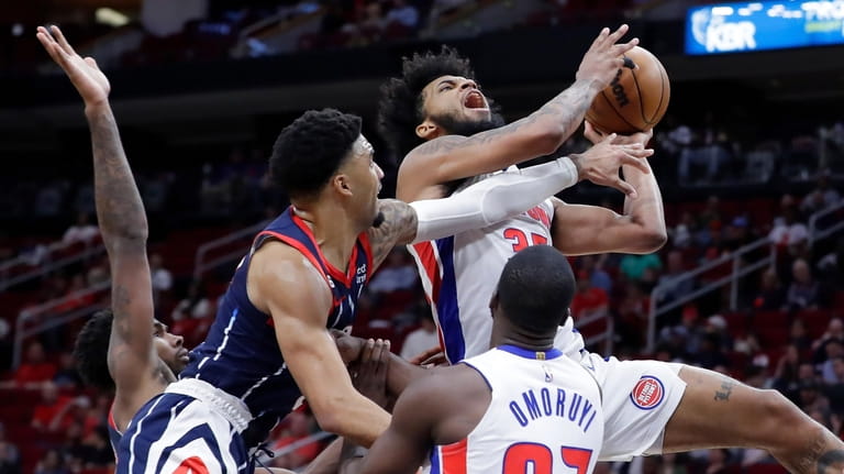 Detroit Pistons forward Marvin Bagley III, top right, is fouled...