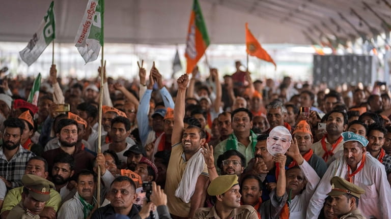 FILE- Supporters of India's ruling Bharatiya Janata Party (BJP) react...