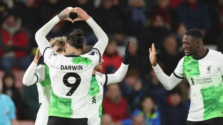 Liverpool's Darwin Nunez, left, celebrates with teammates after scoring his...