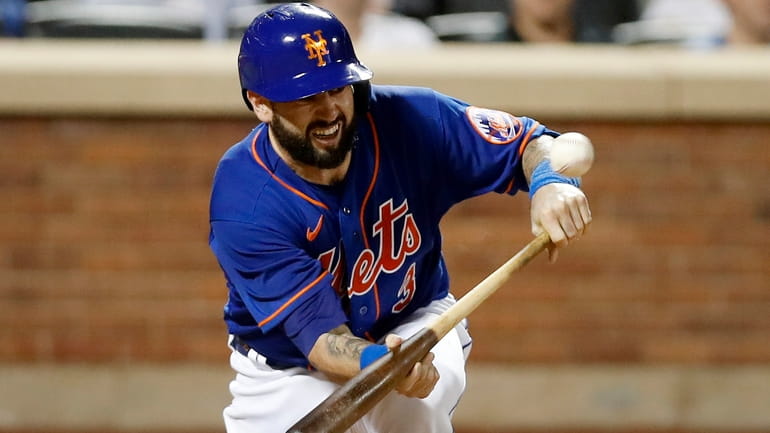 Tomas Nido #3 of the Mets connects on run scoring sacrifice...