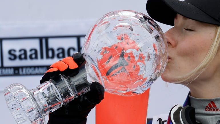 United States' Mikaela Shiffrin kisses the trophy for the alpine...