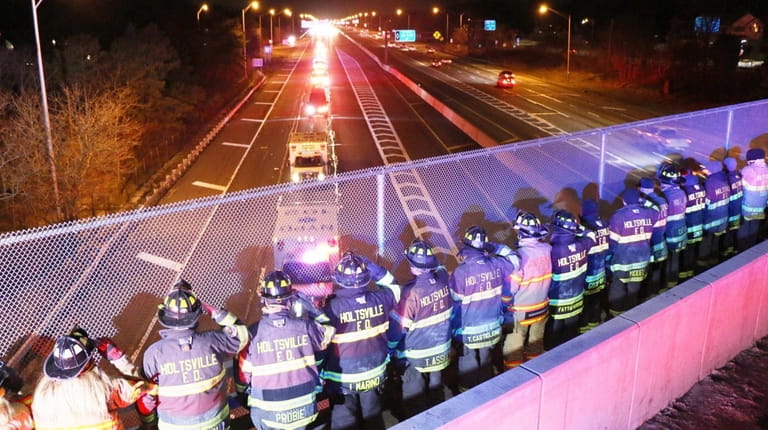Holbrook and Holtsville firefighters on the Exit 61 overpass of the...
