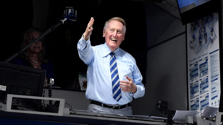 Los Angeles Dodgers announcer Vin Scully greets the crowd before...