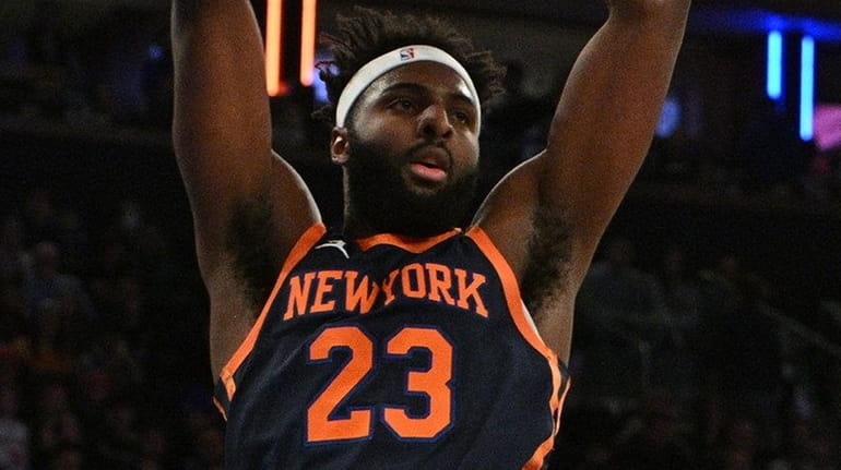 Knicks center Mitchell Robinson dunks past Raptors forward Pascal Siakam...