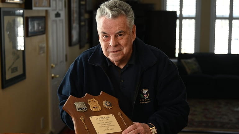 Former Rep. Peter King with his fathers' police badges, at...