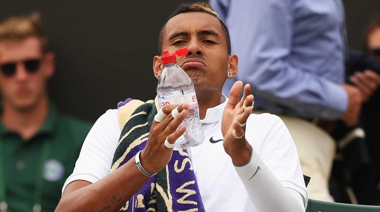 Nick Kyrgios of Australia takes a drink during a break...