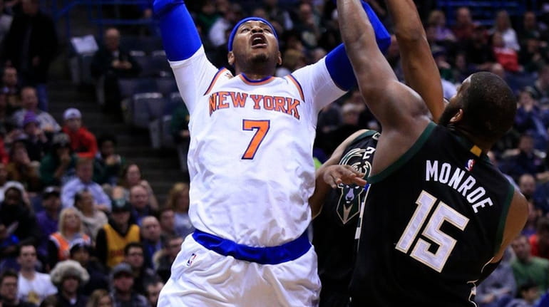 New York Knicks forward Carmelo Anthony, left, is fouled by...