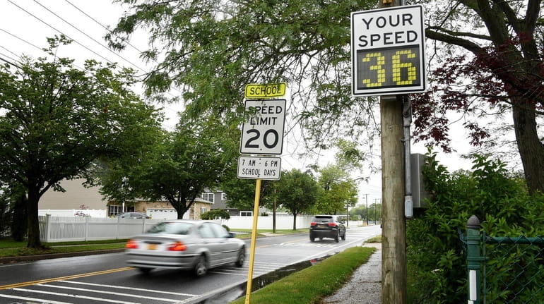 Cars drive over the speed limit at the intersection of...