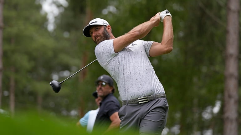 Dustin Johnson of the United States plays from the 4th...