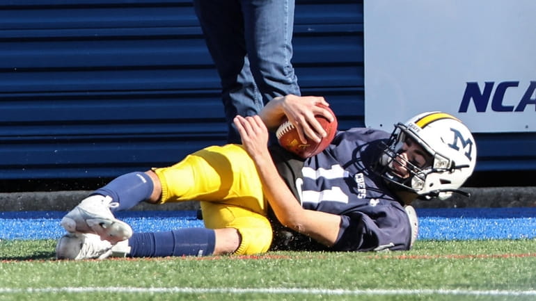 Massapequa quarterback Joey Diesso slides into the end zone for...
