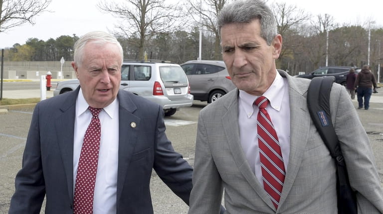 Former Suffolk County District Attorney Thomas Spota, left, leaves federal...