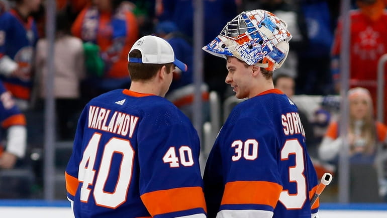 Ilya Sorokin #30 and Semyon Varlamov #40 of the Islanders celebrate...