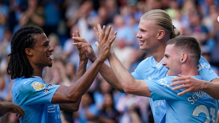 Manchester City's Erling Haaland, second right, celebrates with teammates after...