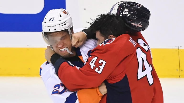 Capitals right wing Tom Wilson fights Islanders left wing Anders Lee during the...