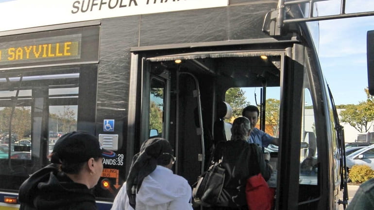 Passengers board a Suffolk County Transit Bus in Lake Grove....