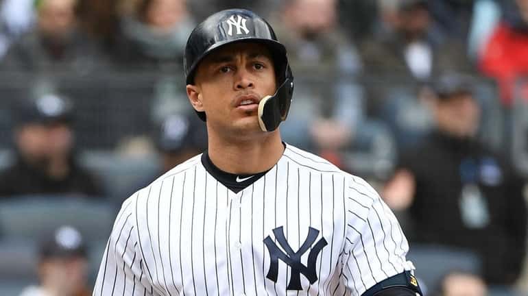 Yankees rightfielder Giancarlo Stanton looks on after he lines into...