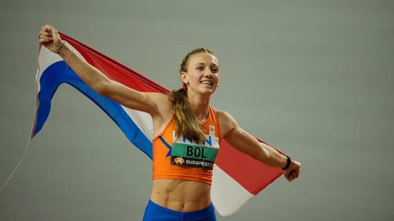 Winner Femke Bol, of the Netherlands celebrates after the final...