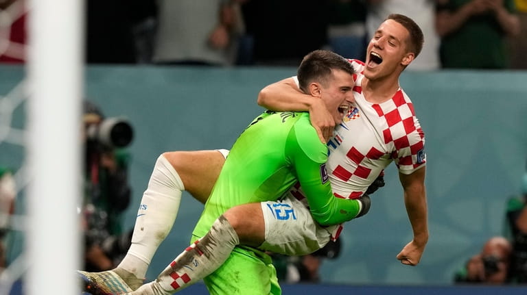 Croatia's Mario Pasalic celebrates with Croatia's goalkeeper Dominik Livakovic after...