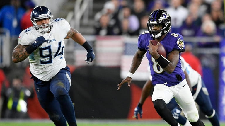 Titans nose tackle Austin Johnson chases Ravens quarterback Lamar Jackson during...