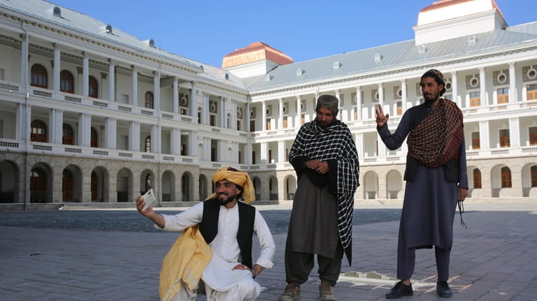 Afghans take selfies at the renovated Darul Aman Palace in...