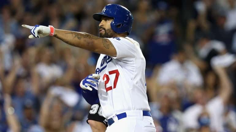 Matt Kemp #27 of the Los Angeles Dodgers reacts after...