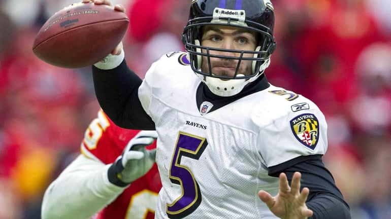 Baltimore Ravens quarterback Joe Flacco evades being sacked in the...