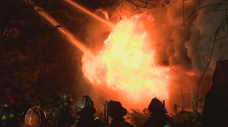 Firefighters battle a fatal fire on Elder Avevue in Farmingville...