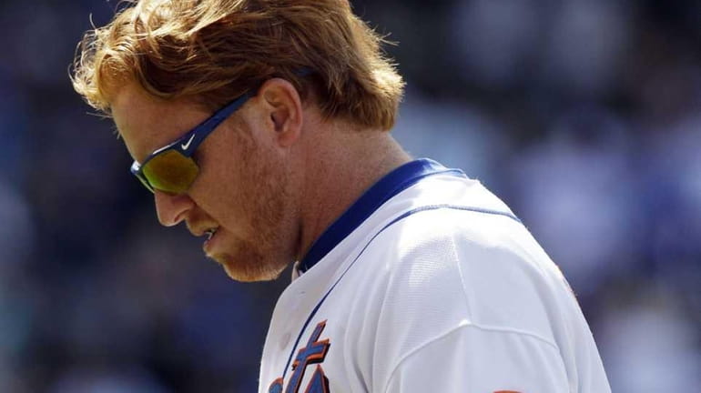 New York Mets' Justin Turner reacts after being thrown out...