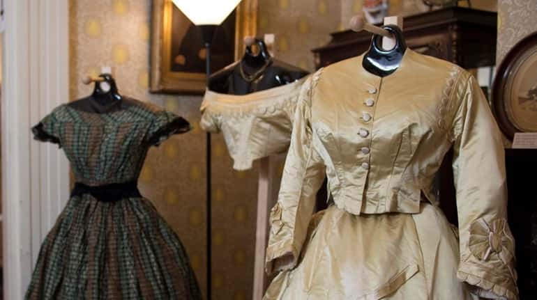 An elaborate four-piece silk dress from 1870 is on display...