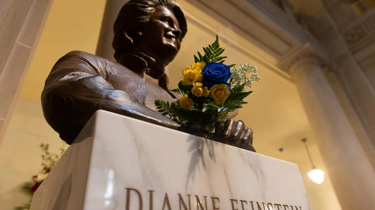 Flowers rest at a bust depicting U.S. Sen. Dianne Feinstein...