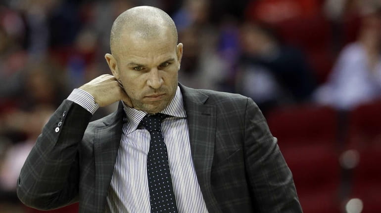 Nets coach Jason Kidd adjusts his collar during a timeout...