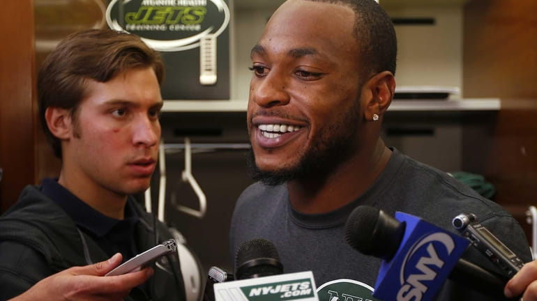 Jets wide receiver Percy Harvin talks to the media at...